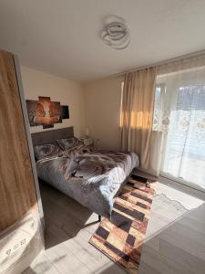 a bedroom with a bed and a large window at Zum Löwen Apartments in Reutte