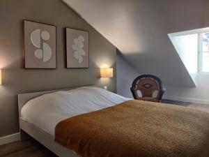 a bedroom with a bed and two pictures on the wall at Grand appart 2 chambres - Hyper centre - Calme in Chinon