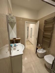 a bathroom with two sinks and a toilet and a mirror at Milano Central in Milan +20 photos