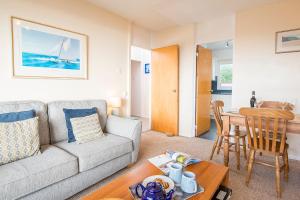 a living room with a couch and a table at Ty Peggie in Haverfordwest