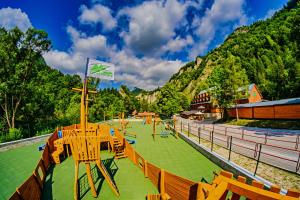 a playground with tables and chairs in front of a mountain at U GORAĽA in Lesnica