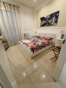 a bedroom with a bed with a colorful comforter at Milano Central in Milan