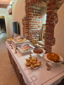 a buffet with several plates of food on a table at Bed and Breakfast Cascina Morelli 1862 in Avigliana