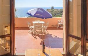 a table and chairs with an umbrella on a patio at Casa Mario in Torre Dei Corsari