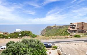 a house on a hill next to the ocean at Casa Mario in Torre Dei Corsari