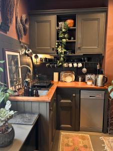 a kitchen with gray cabinets and a counter top at The Goose Garden in Hebden Bridge