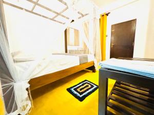 a bedroom with two beds and a table in it at Lucky Eagle Nest in Tangalle +35 photos