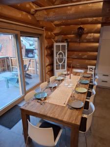 a dining room with a wooden table and chairs at Ferienblockhaus "Glashütte" mit Sauna, Todtmoos in Todtmoos