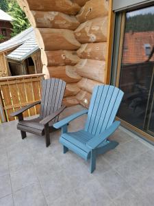 two chairs sitting on a patio in front of a log cabin at Ferienblockhaus "Glashütte" mit Sauna, Todtmoos in Todtmoos +37 photos
