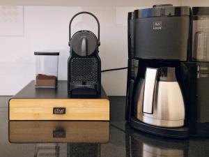 a coffee maker sitting on a counter next to a coffeemaker at FEWOCASA Central Family Apartment Rorschach - Lake Constance - Near St Gallen in Rorschach