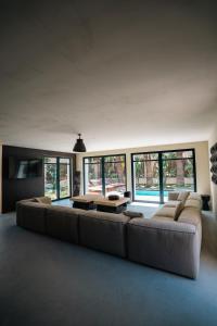 a large living room with a couch and a table at La Vague - Saint Tropez in Saint-Tropez