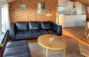 a living room with a leather couch and a table at Amazing Home In Egernsund With Wifi in Egernsund