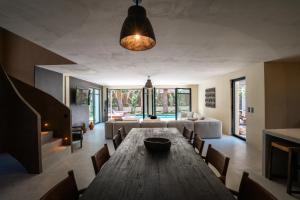 a living room with a wooden table and chairs at La Vague - Saint Tropez in Saint-Tropez