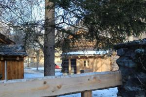 a wooden fence in front of a log cabin at Heidi Hütte in Döllach