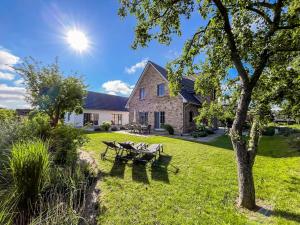 a house with two picnic tables in the yard at Ferienhaus Libelle - Feriendomizil für 14 Pers - Haupt- und Nebenhaus in Rankwitz +24 photos