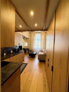 a kitchen and living room with a couch and a table at Justinrent 1 in Legnica