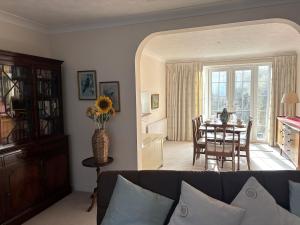 a living room with a couch and a table at Upperton Townhouse in Eastbourne