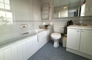 a white bathroom with a toilet and a sink at Upperton Townhouse in Eastbourne +26 photos
