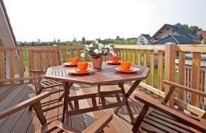 a wooden table on a deck with food on it at Ferienhaus Sandra in Wohlenberg