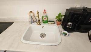 a kitchen counter with a sink and a coffee maker at Stunning Sea-View Villa w Access to Shared Pools in Mikonos +15 photos