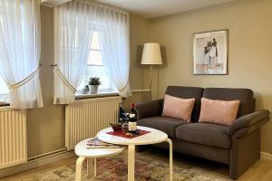 a living room with a couch and a table at Haus 25 in Oldsum in Oldsum