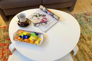 a white table with a book and a pen and glasses at Haus 25 in Oldsum in Oldsum +15 photos