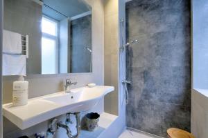 a bathroom with a sink and a shower at eliamaria artistic house in Lefkada +30 photos