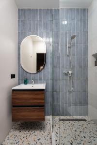 a bathroom with a sink and a shower with a mirror at Blueloft 47 l studio with balcony Tashkent City Center in Tashkent +11 photos