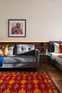 a living room with a couch and a table at Blueloft 47 l studio with balcony Tashkent City Center in Tashkent
