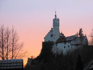 a castle on top of a hill at sunset at Ferienwohnung Haus Wagnershoehe in Gößweinstein