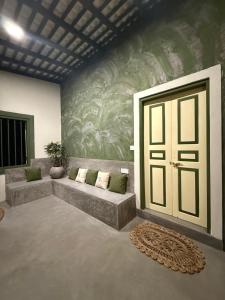 a living room with a couch and a door at Wanora Eco Villa in Dickwella