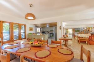 a kitchen and dining room with a wooden table at Río Mar Cumayasa in La Romana
