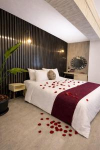a bedroom with a large bed with red roses on it at zebra otel buca in Buca
