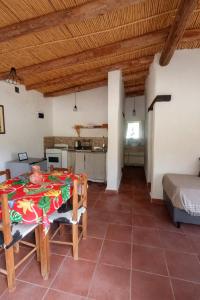 a kitchen and dining room with a table and chairs at El Sueñero Tilcara in Tilcara