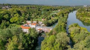 an aerial view of a building on a bridge over a river at Close to Disney & Paris in Lagny