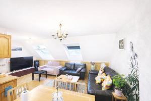 a living room with a couch and a table at Close to Disney & Paris in Lagny