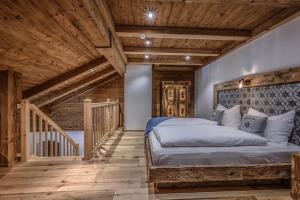 a bedroom with a large bed and wooden ceilings at Ascherhof in Thiersee