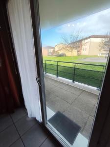 a sliding glass door with a view of a yard at nice apartment strategic location in Muret