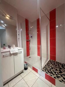 a bathroom with a shower with red and white walls at Agape Hotel Niort- Bessines in Bessines +33 photos