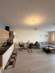 a living room with a couch and a table at Zum Löwen Apartments in Reutte