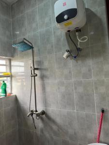 a shower with a camera on the wall of a bathroom at Tranquil in Lekki