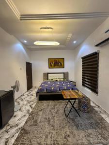 a room with a bed and a table in it at Tranquil in Lekki