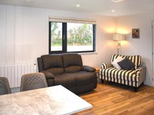 a living room with a couch and a chair at Lodge 5 - Uk51086 in Lyme Regis