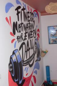 a wall with a sign that reads fitness federation for every day at Riad R Art in Marrakesh