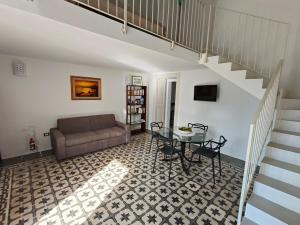 a living room with a table and a couch at Aquarius Salento in Acquarica del Capo