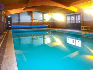a large swimming pool with blue water at Lodge 8 - Uk51076 in Lyme Regis