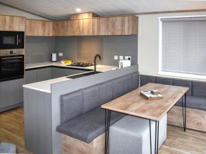 a kitchen with a bench and a table in it at Lodge 8 - Uk51076 in Lyme Regis