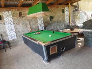 a pool table in a living room with a pool table at Katalin Apartmanok in Hajdúnánás