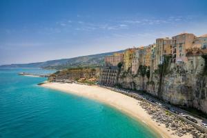 an aerial view of a beach with buildings and the ocean at Essenza Mediterranea Tropea in Tropea