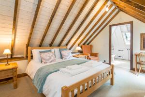a bedroom with a large bed in a room with wooden ceilings at Coach House in Pembroke